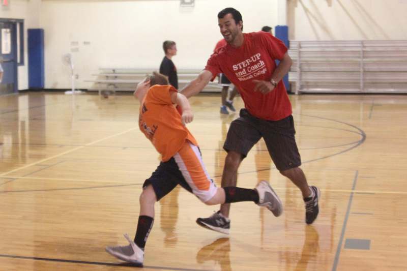 a man and boy playing basketball