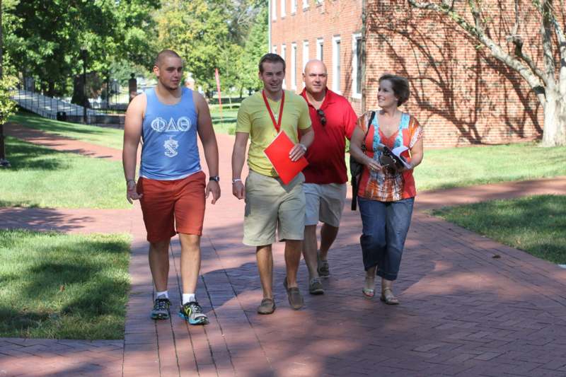 a group of people walking on a brick path