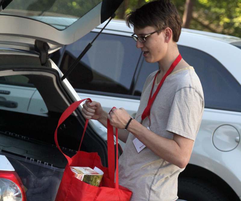 a man opening a red bag