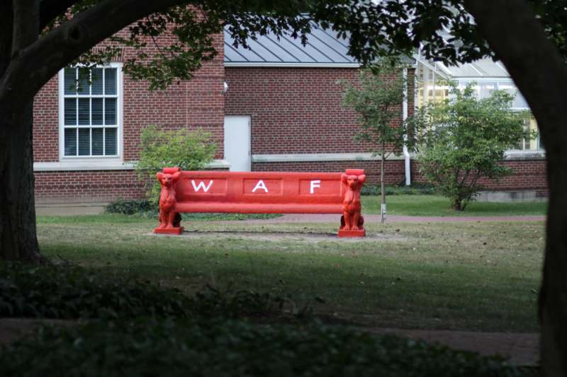 a red bench with lions on it