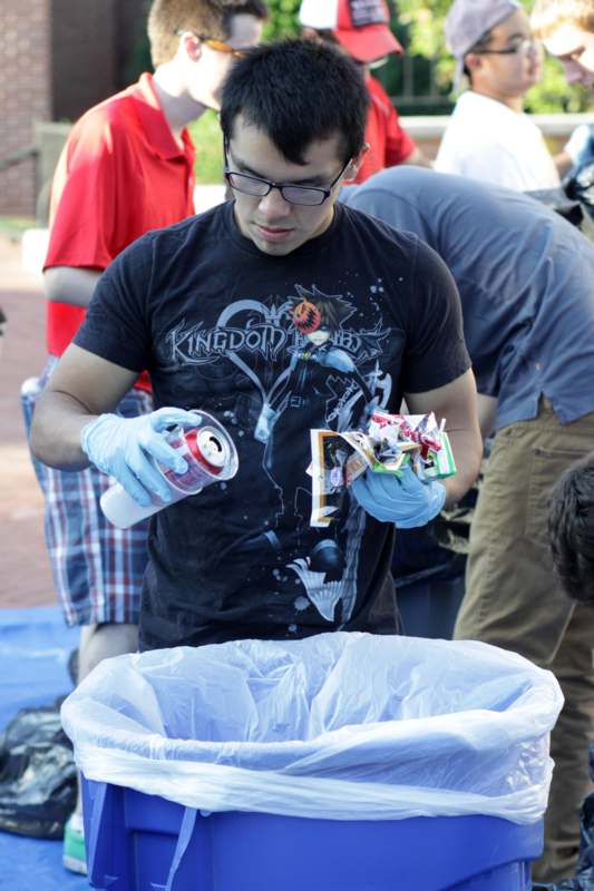 a man wearing gloves and holding a spray can