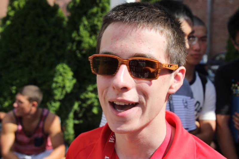 a man wearing sunglasses and a red shirt
