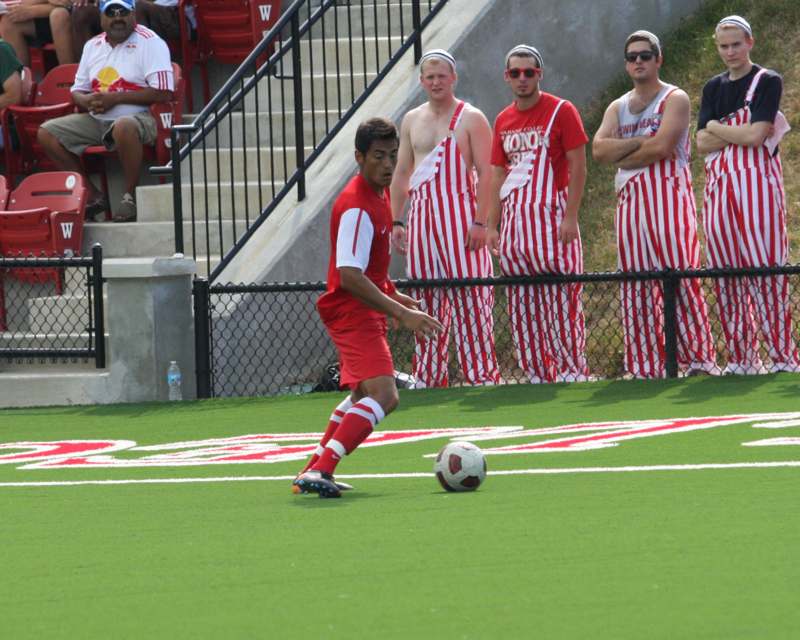 a group of men in red and white uniforms playing football