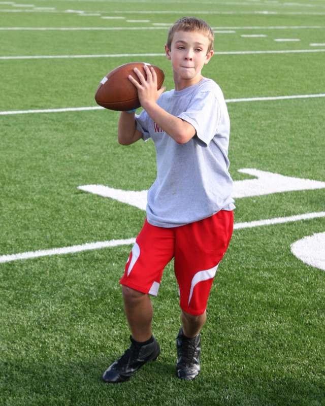 a boy holding a football