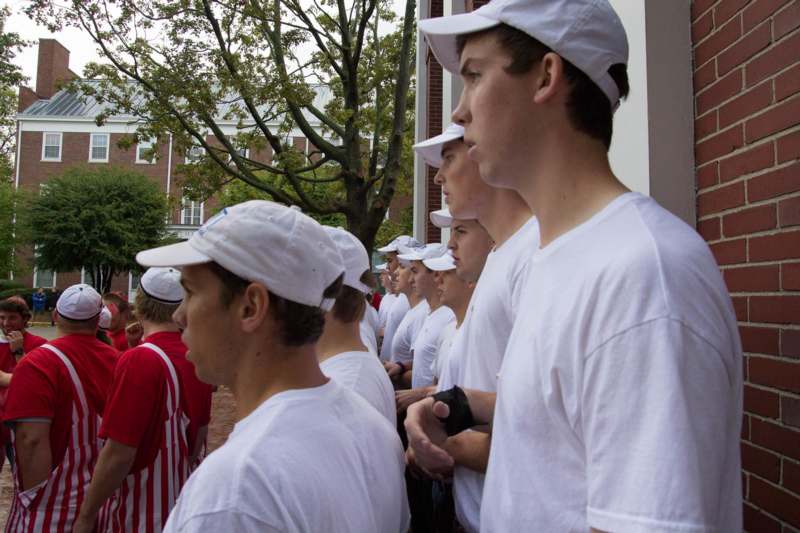 a group of people in white shirts