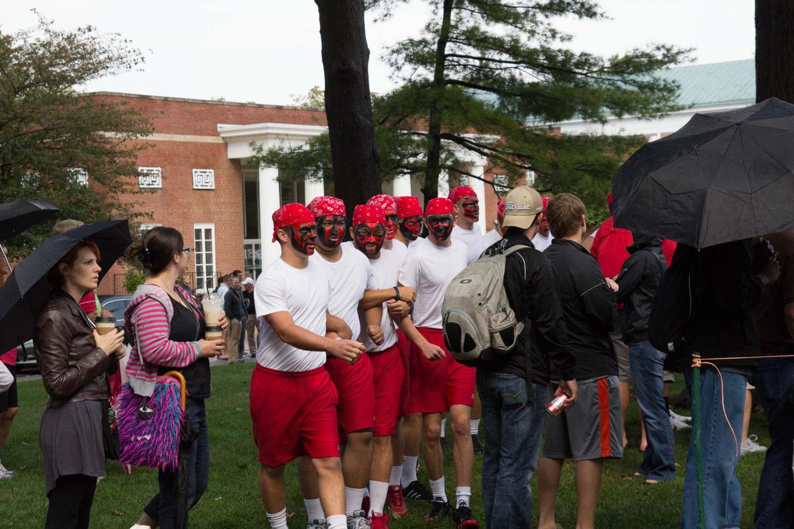 a group of people wearing red and white shirts and red bandanas