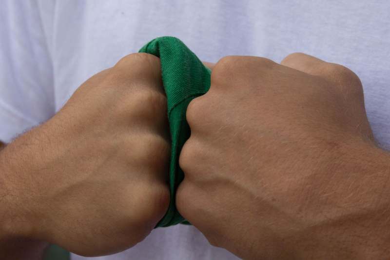 a person pulling a green shirt