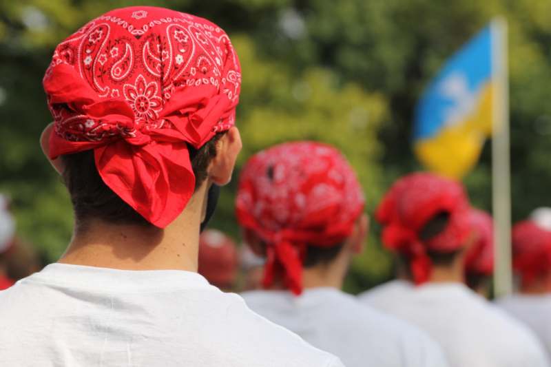a group of people wearing red bandanas