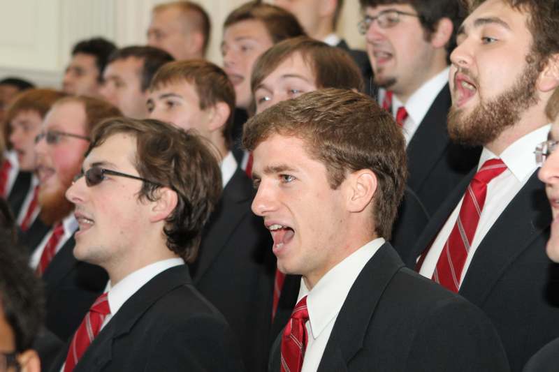 a group of men in suits singing