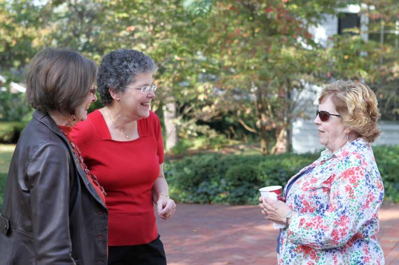a group of women talking outside