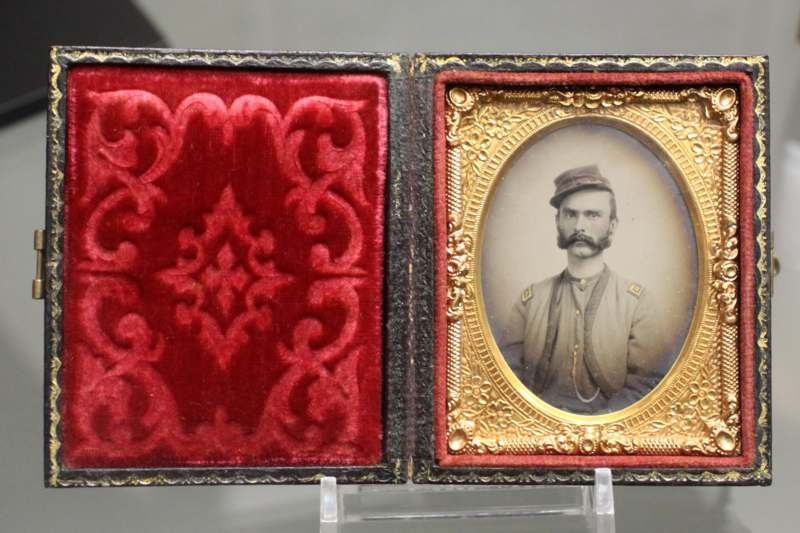 a framed photo of a man in a red velvet case