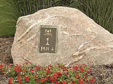 a large rock with a sign on it