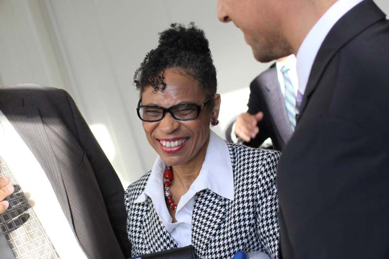 a woman in a checkered suit smiling