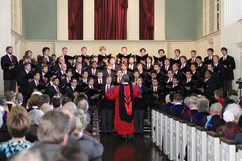 a choir of men singing in a church