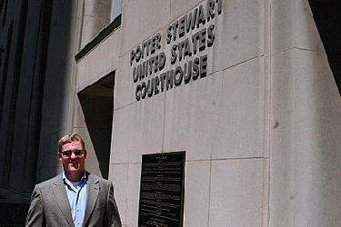 a man standing in front of a courthouse