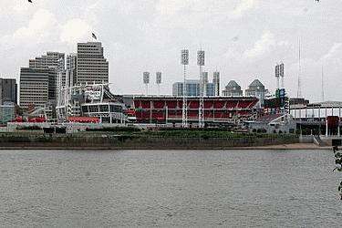 a stadium and water with a city in the background