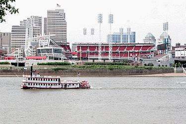 a boat in the water with a stadium in the background