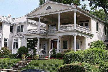 a large white house with a large porch