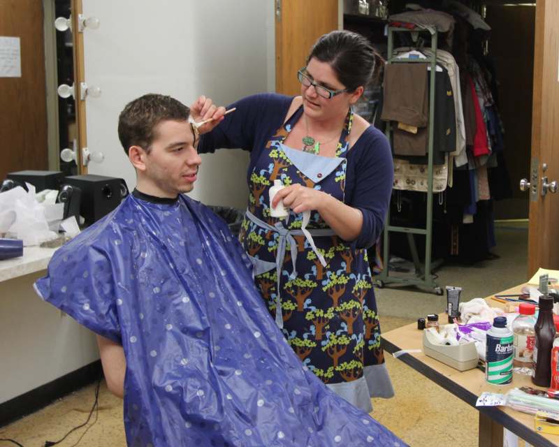 a woman cutting a man's hair