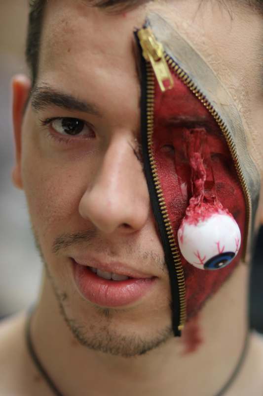 a man with a zipper and eyeball