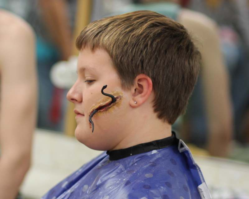 a boy with a snake face paint