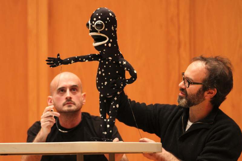 a man holding a puppet