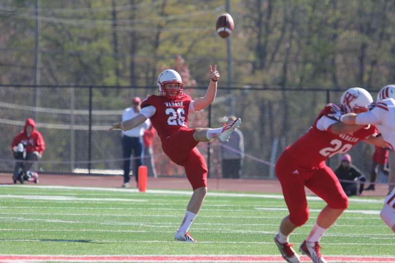 a football player in red uniform catching a football