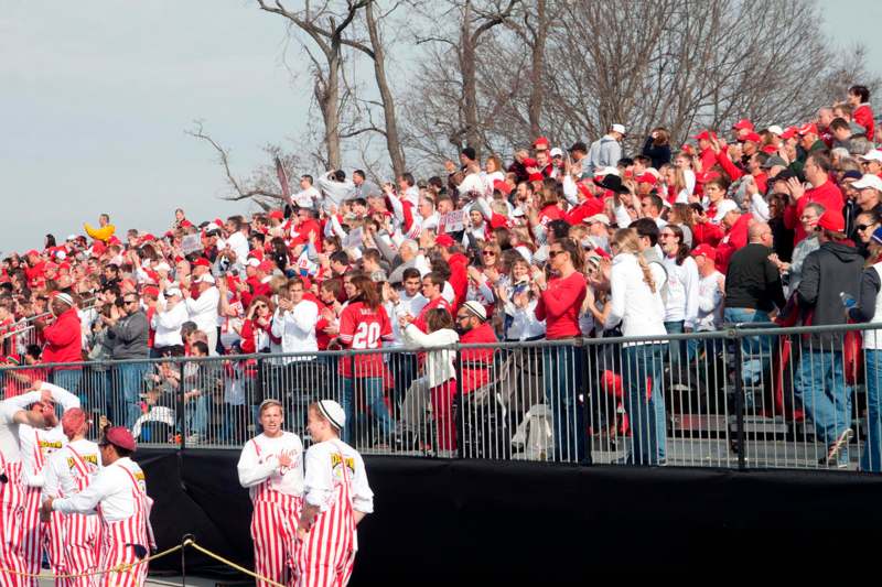 a crowd of people in red and white shirts