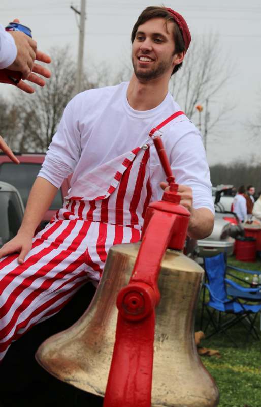 a man in red and white striped overalls and hat