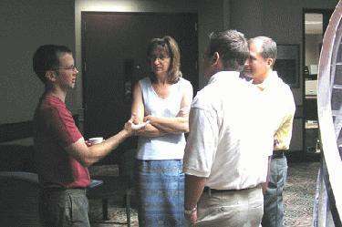 a group of people standing around each other