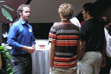 a group of people standing around a table