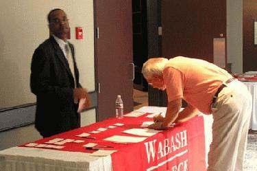 a man signing a document on a table