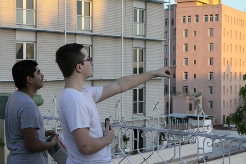 a man pointing to the side of a building