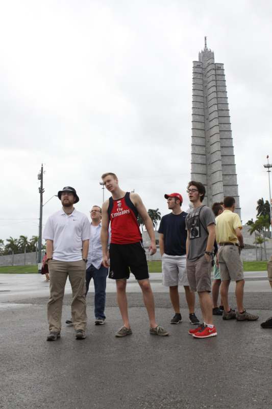 a group of people standing in front of a monument