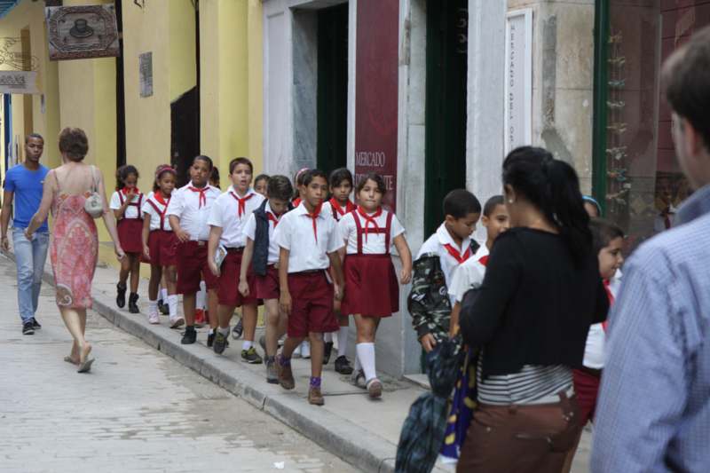 a group of children walking on a street
