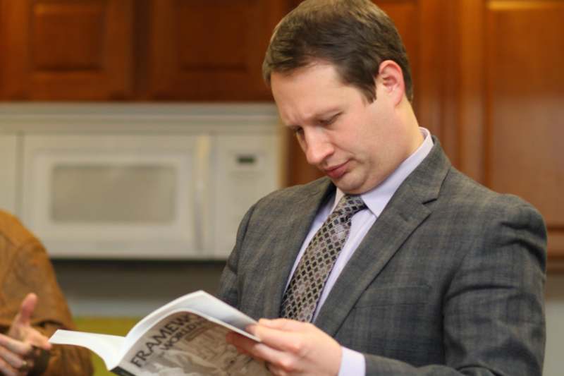 a man in a suit reading a newspaper