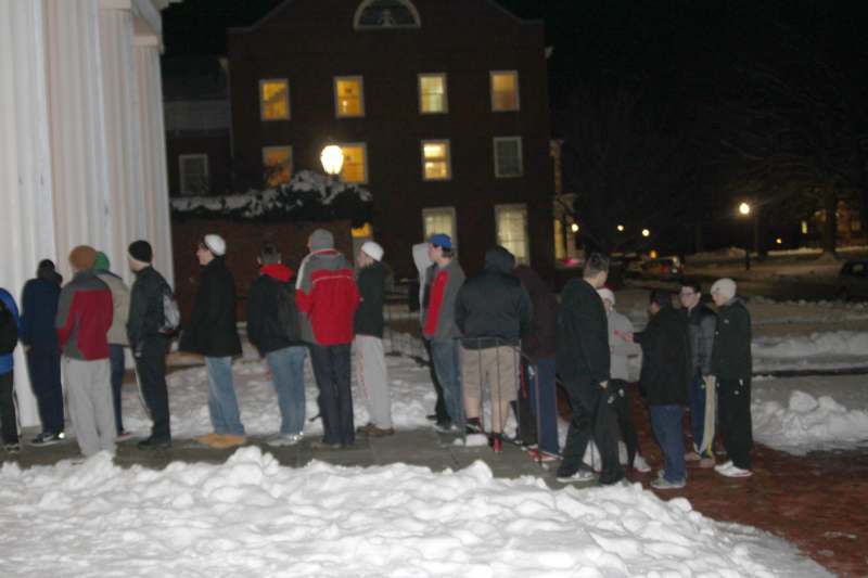 a group of people standing outside in the snow