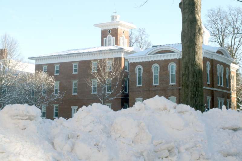 a large pile of snow next to a building