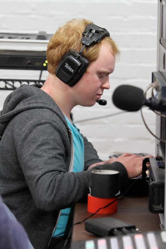 a man wearing headphones and using a computer