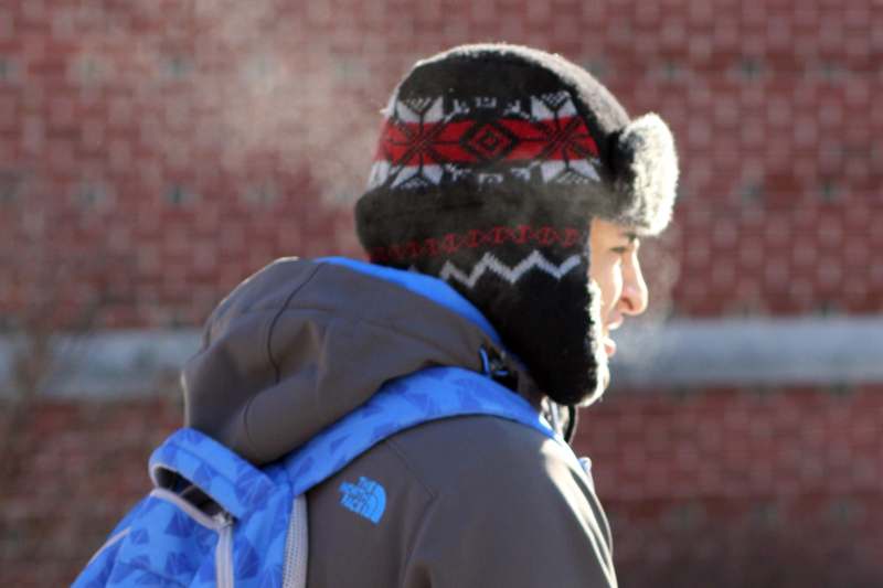 a man wearing a hat and a backpack
