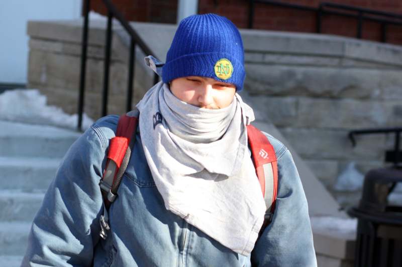 a person wearing a blue hat and scarf