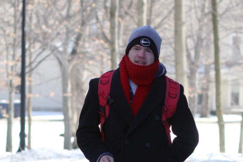 a man wearing a red scarf and a hat