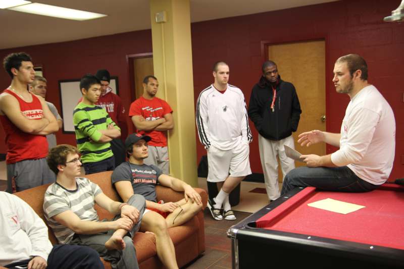 a group of people around a pool table