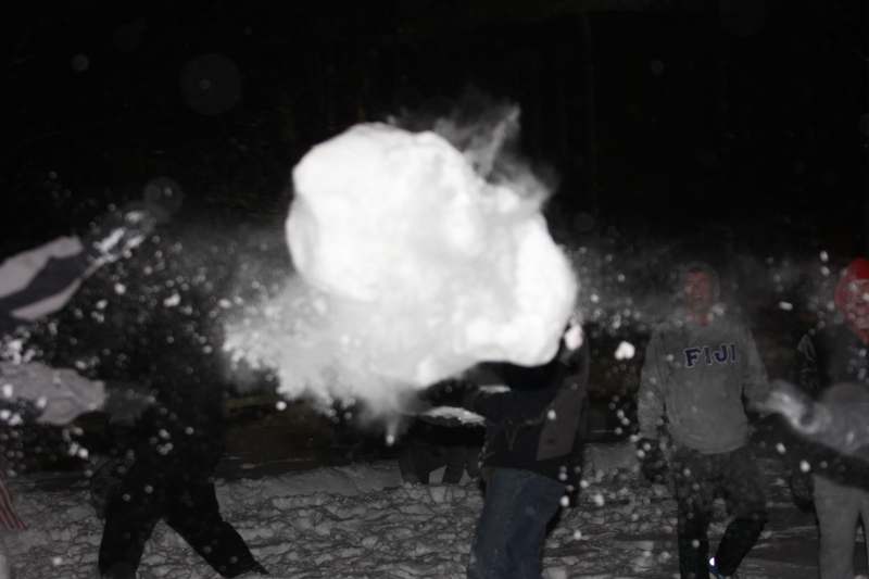 a group of people throwing snow