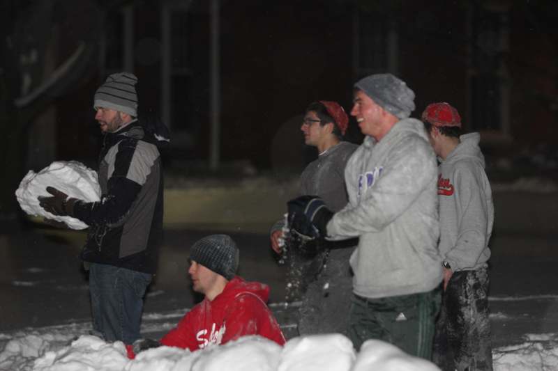 a group of men playing snow