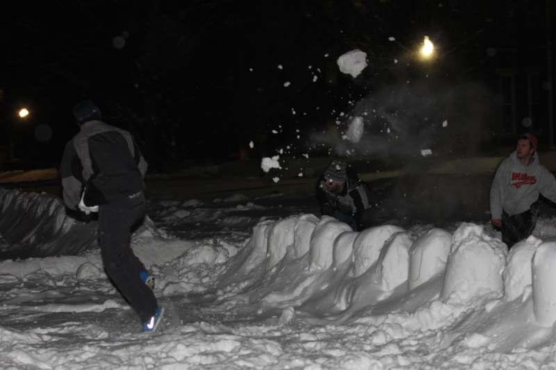 a group of people playing snowballs