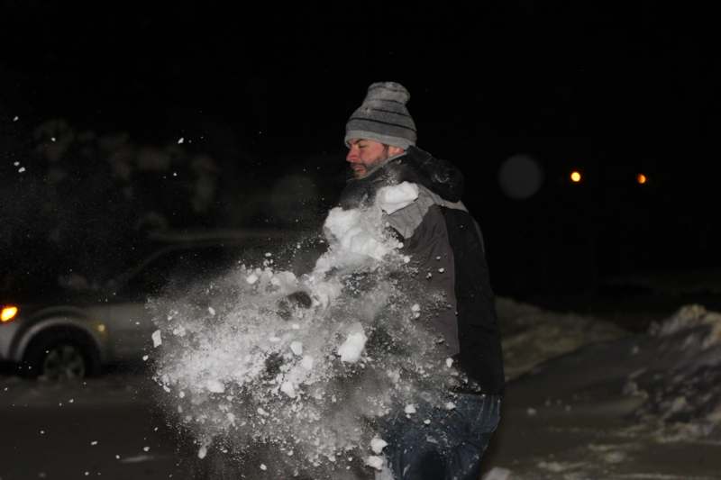 a man throwing snow in the air