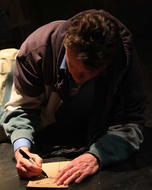 a man writing on a piece of paper