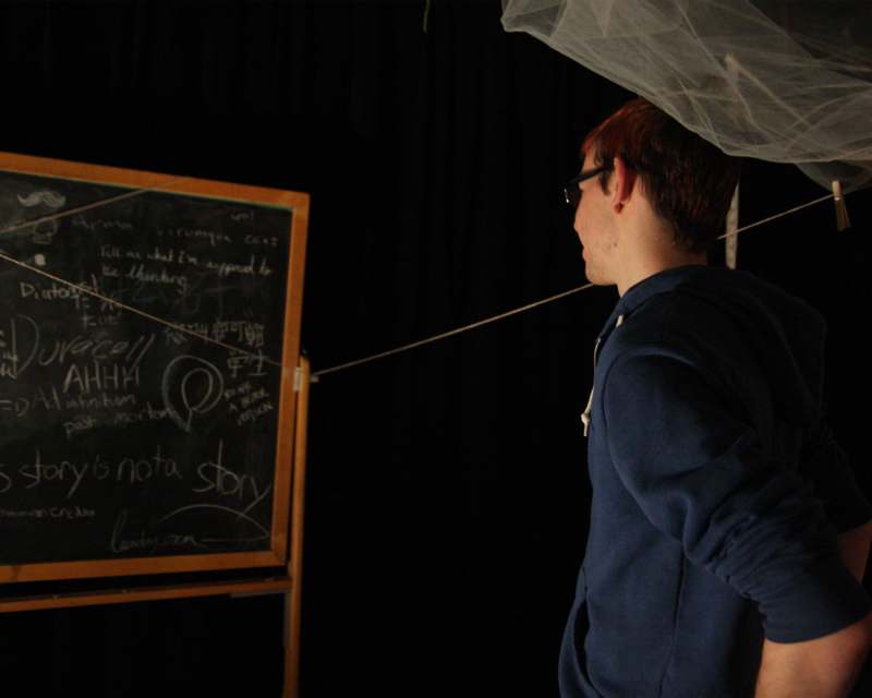 a man standing in front of a chalkboard