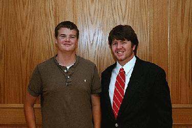 a couple of men standing in front of a wooden door